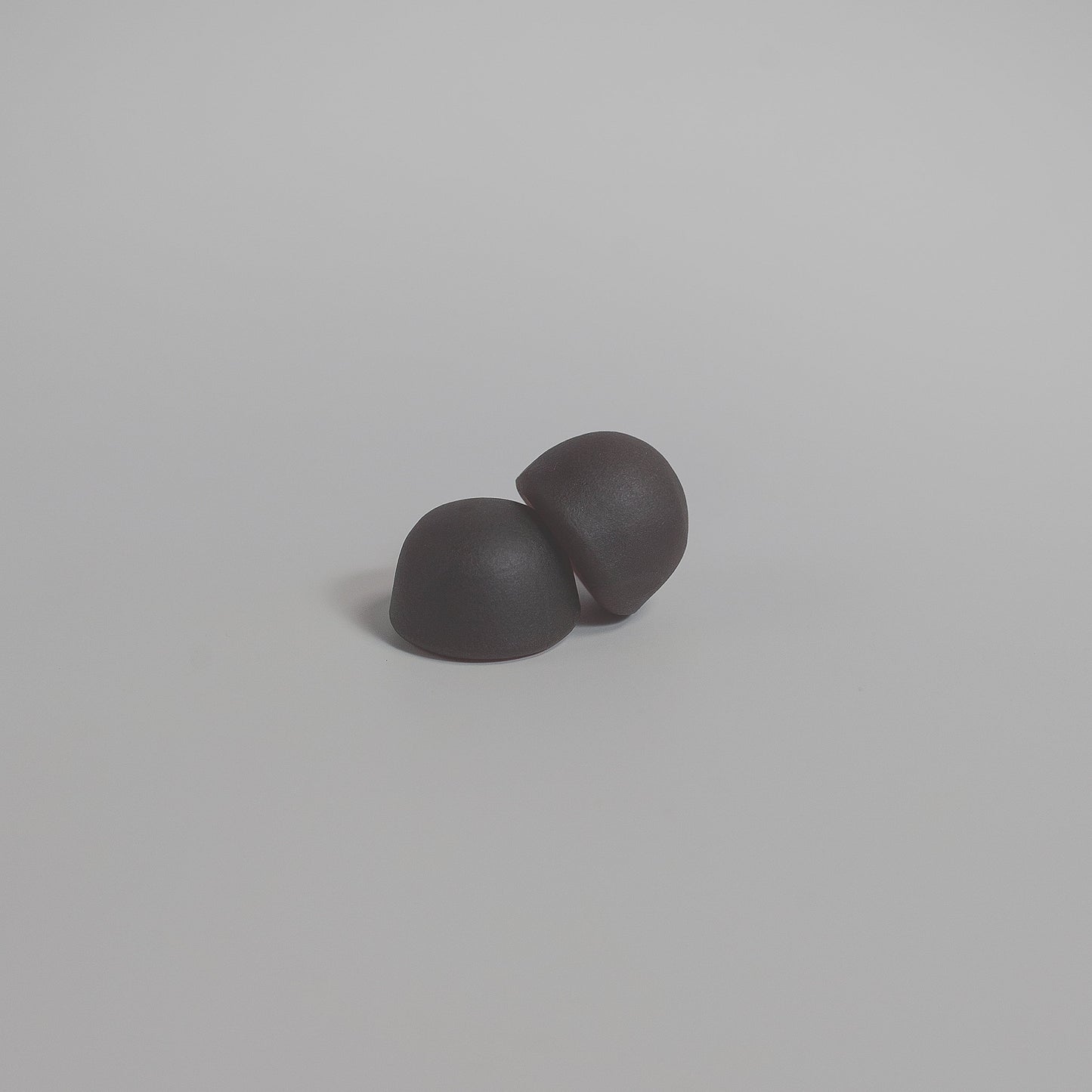 Two mushroom gummies on a light gray background