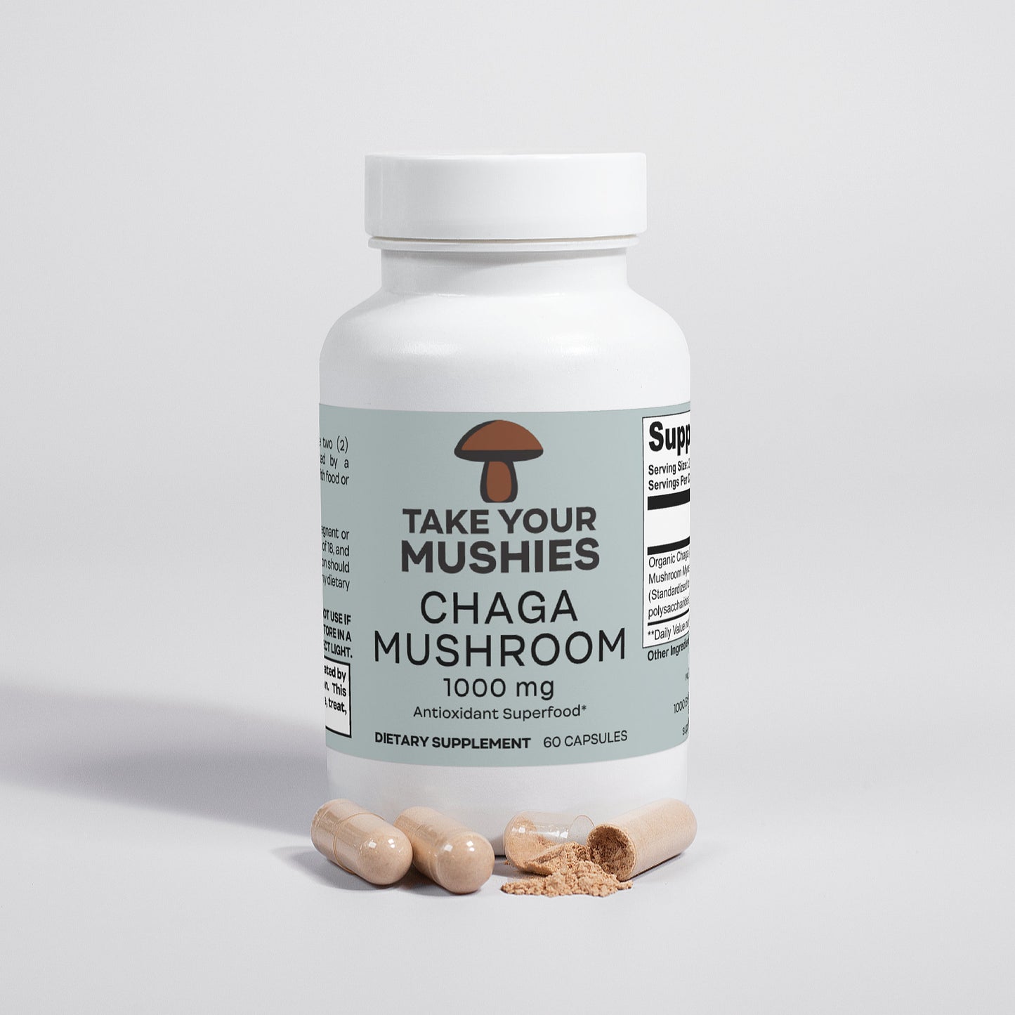Supplement bottle labeled 'Take Your Mushies Chaga Mushroom' on a light gray background