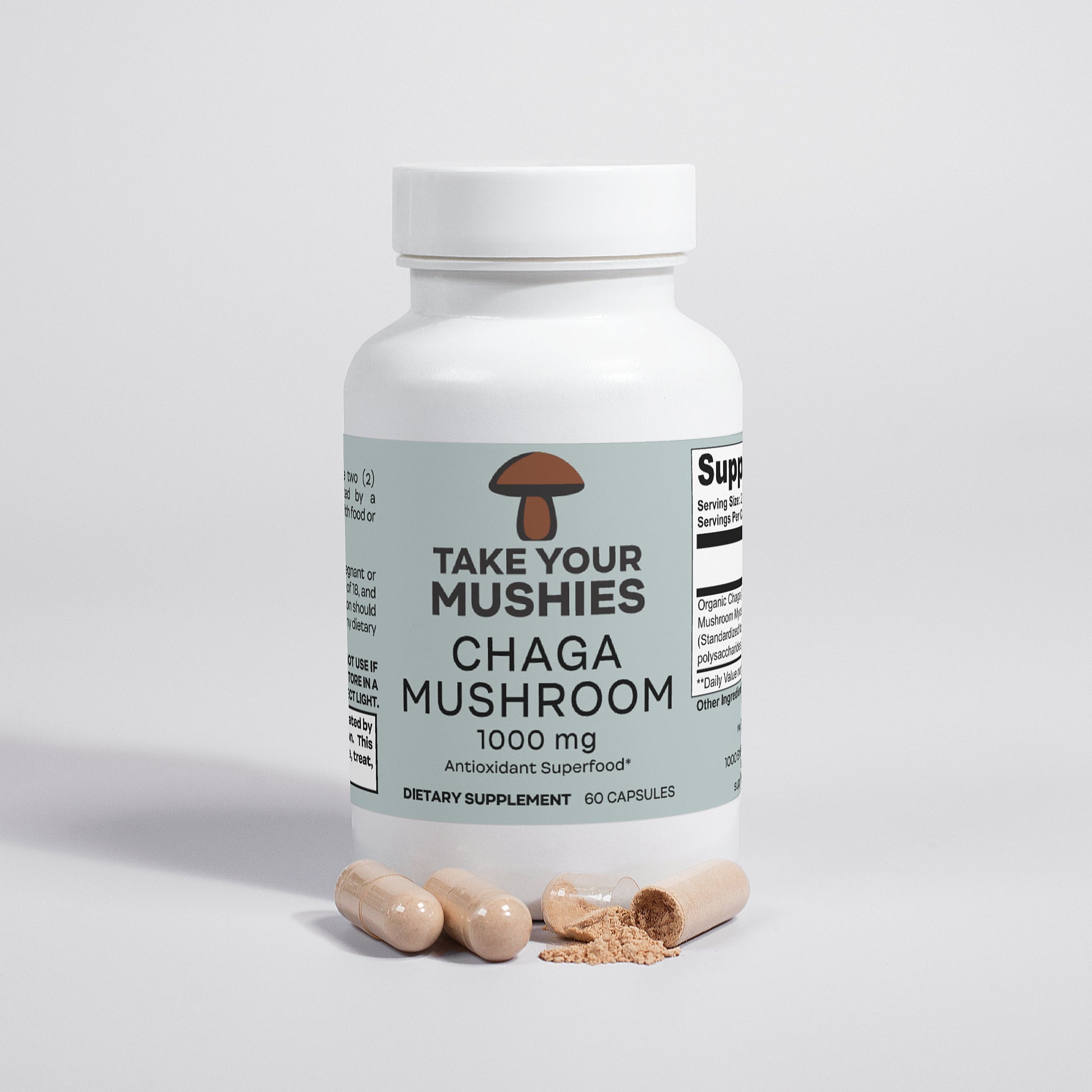 Supplement bottle labeled 'Take Your Mushies Chaga Mushroom' on a light gray background