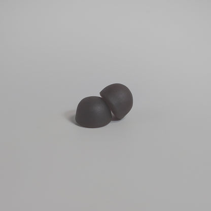 Two mushroom gummies on a light gray background